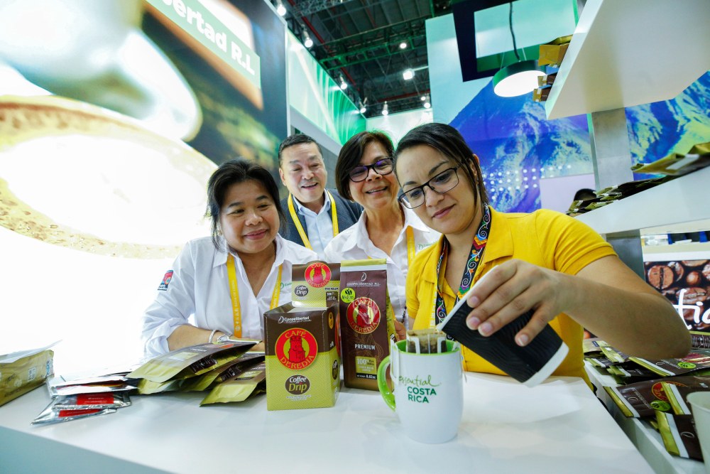 Costa Rican coffee professionals brew coffee at a trade show in China.