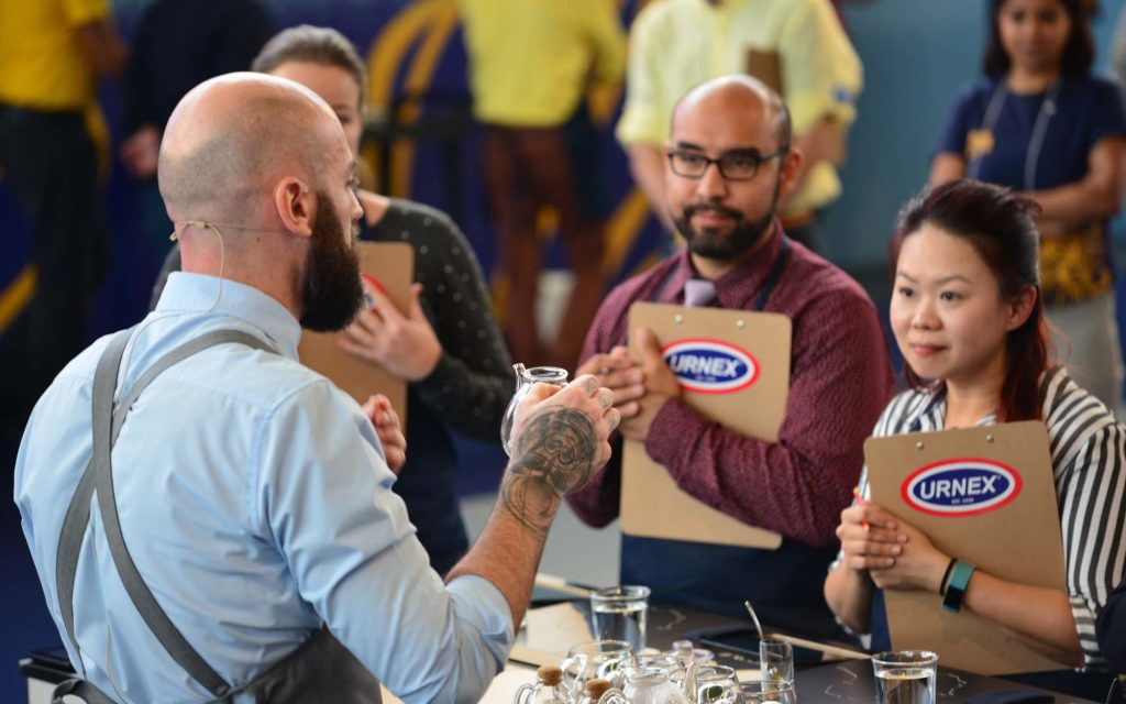 A competitor presents his espresso drink to judges.