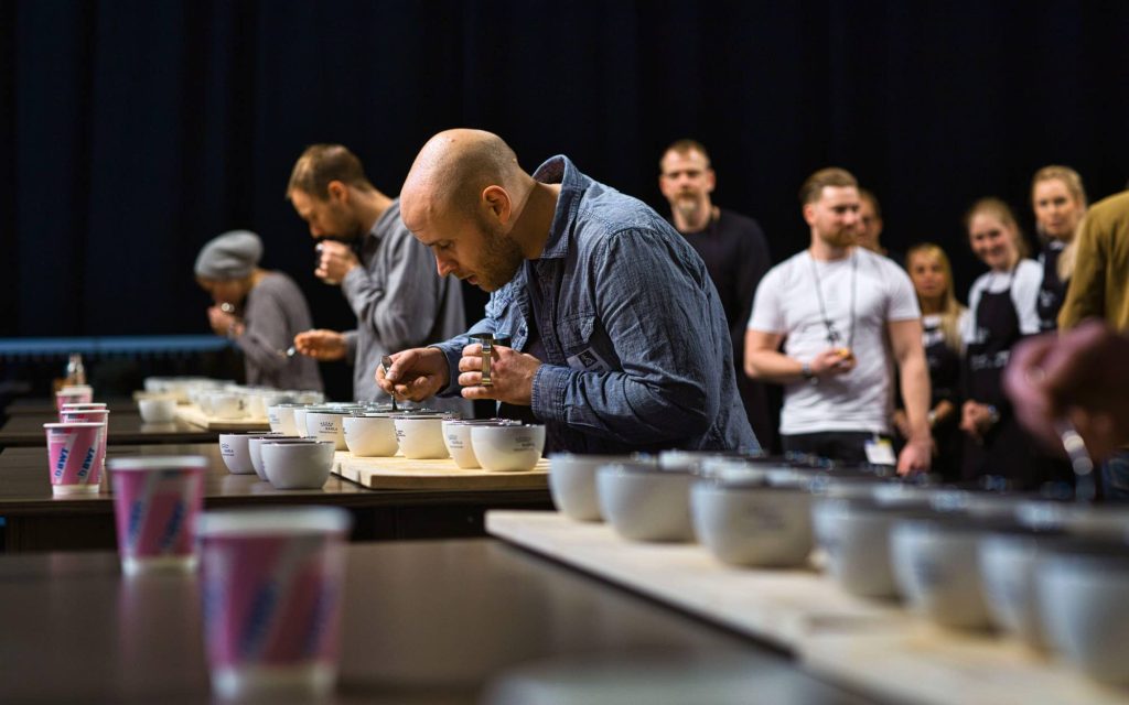 A competitor determines coffee tasting notes at a coffee competition.