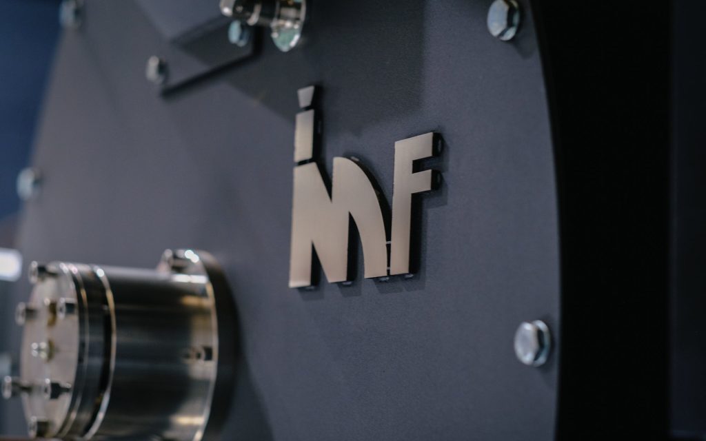 The IMF logo on a piece of coffee equipment.