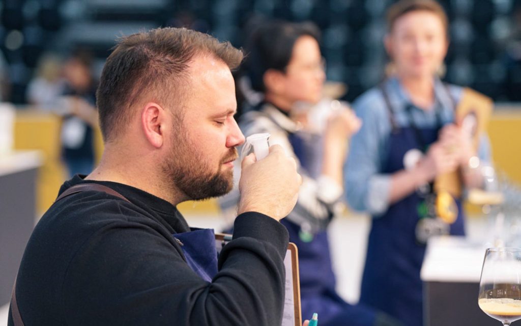 A judge assesses coffee at the World Barista Championship 2023.