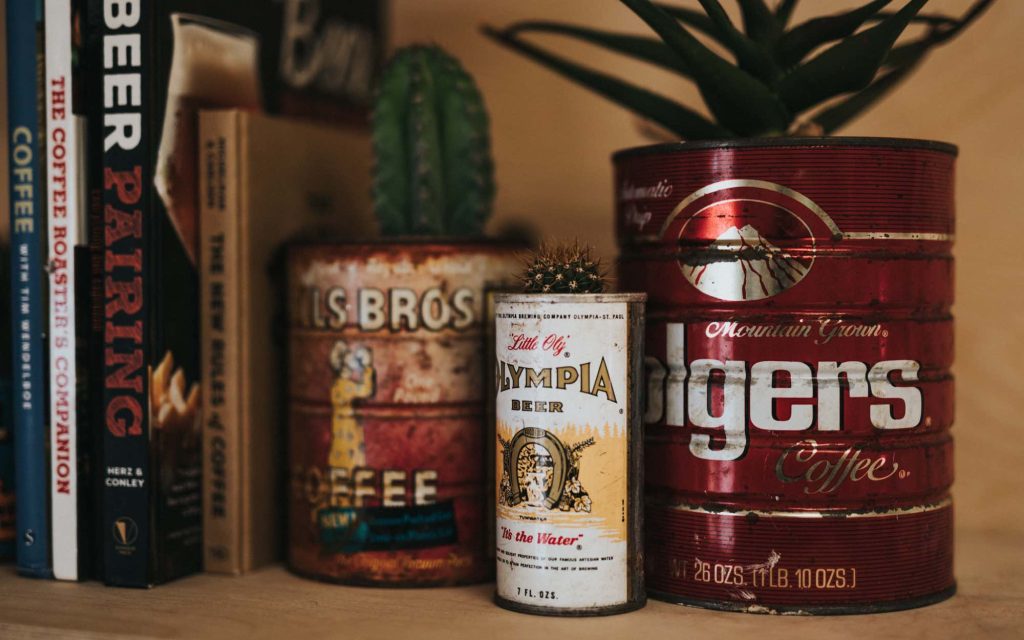 Various vintage tins on a shelf.