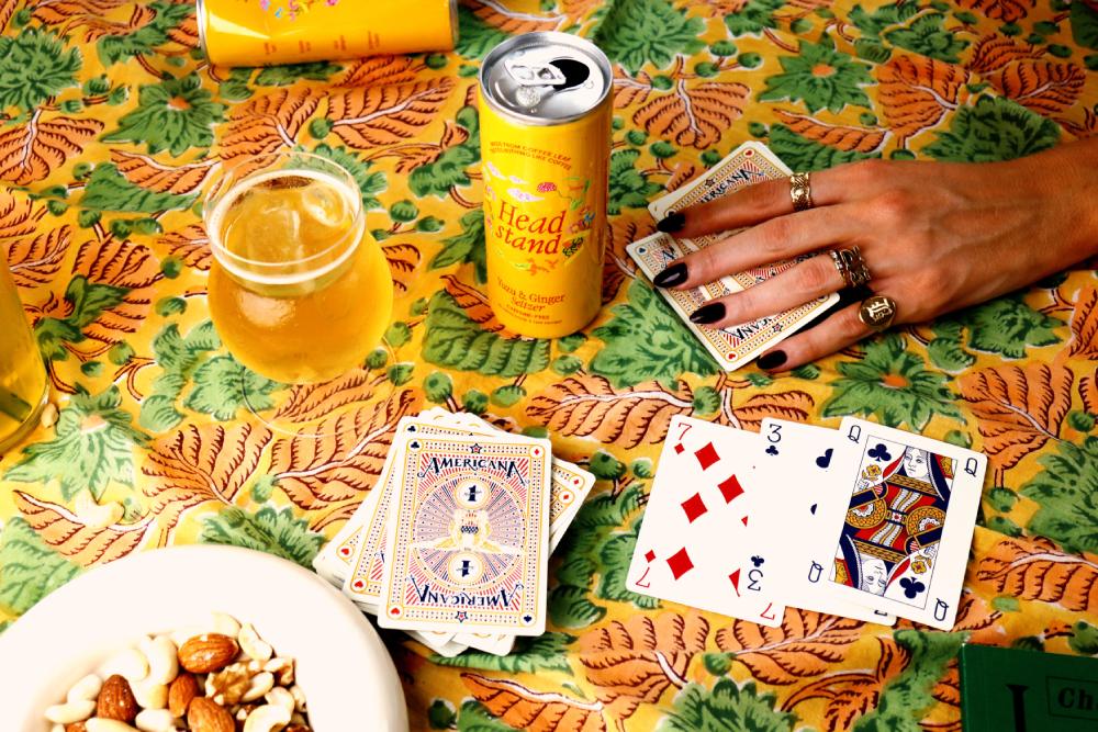 A can of Headstand next to a pack of cards.
