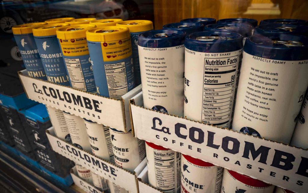 Cans of La Colombe draft nitro cans in a grocery store.