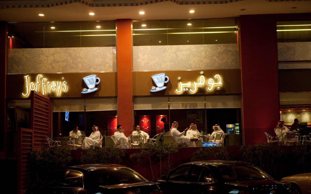 Men sit outside a café in the Middle East.