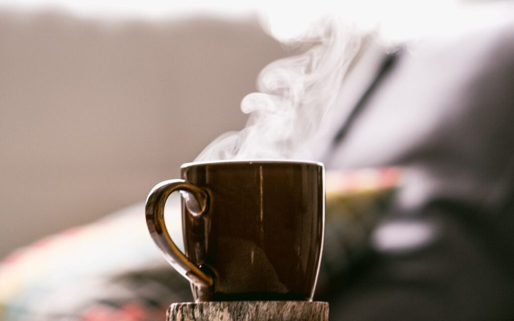 Steam rises after microwaving coffee.